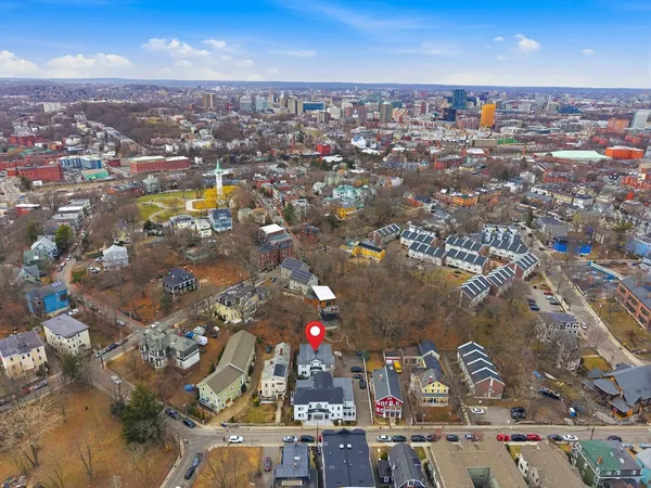 an aerial view of residential houses with city view