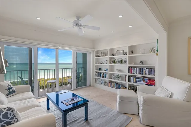 a living room with furniture and a book shelf