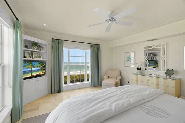 a bedroom with a bed cabinets and window