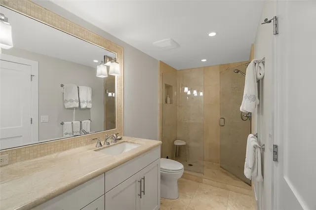 a bathroom with a double vanity sink toilet and shower