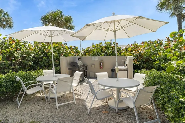 a view of an outdoor sitting area with chairs and an umbrella