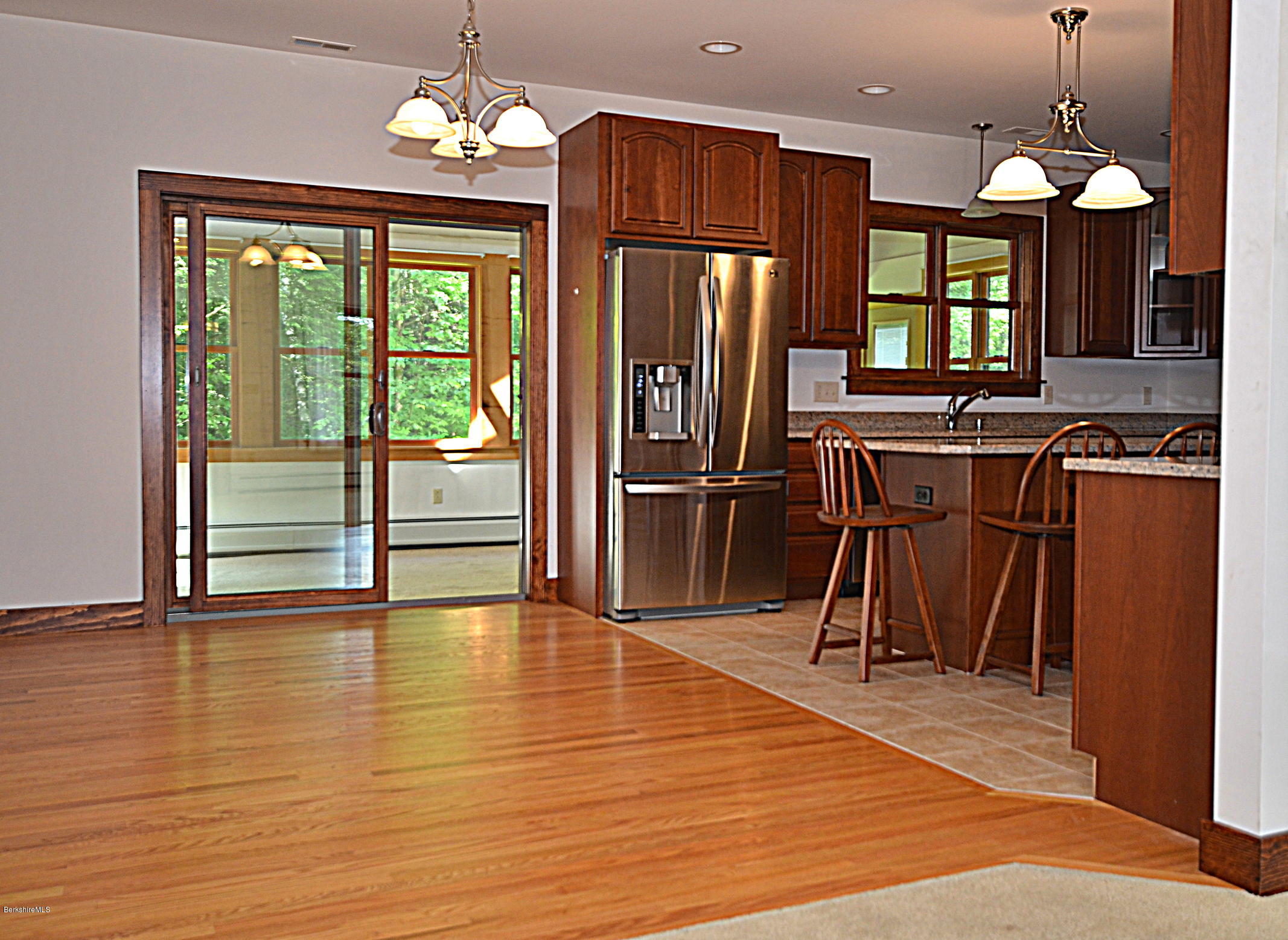 779 Stebbins Road Otis, MA 01253 - Photo 18 of 40 a view of a room with wooden floor stove and kitchen view