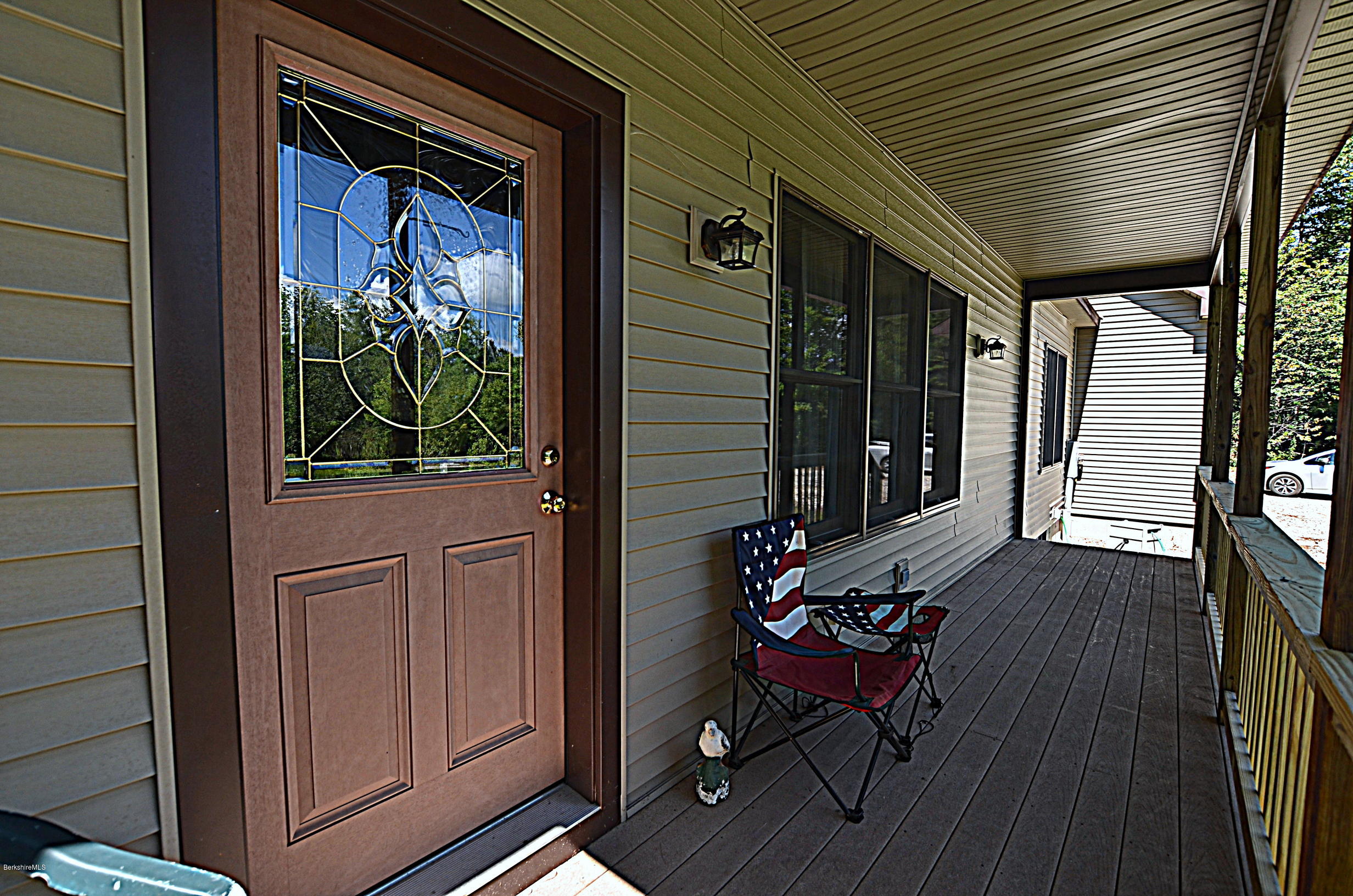 779 Stebbins Road Otis, MA 01253 - Photo 3 of 40 a view of a porch with furniture and floor to ceiling window