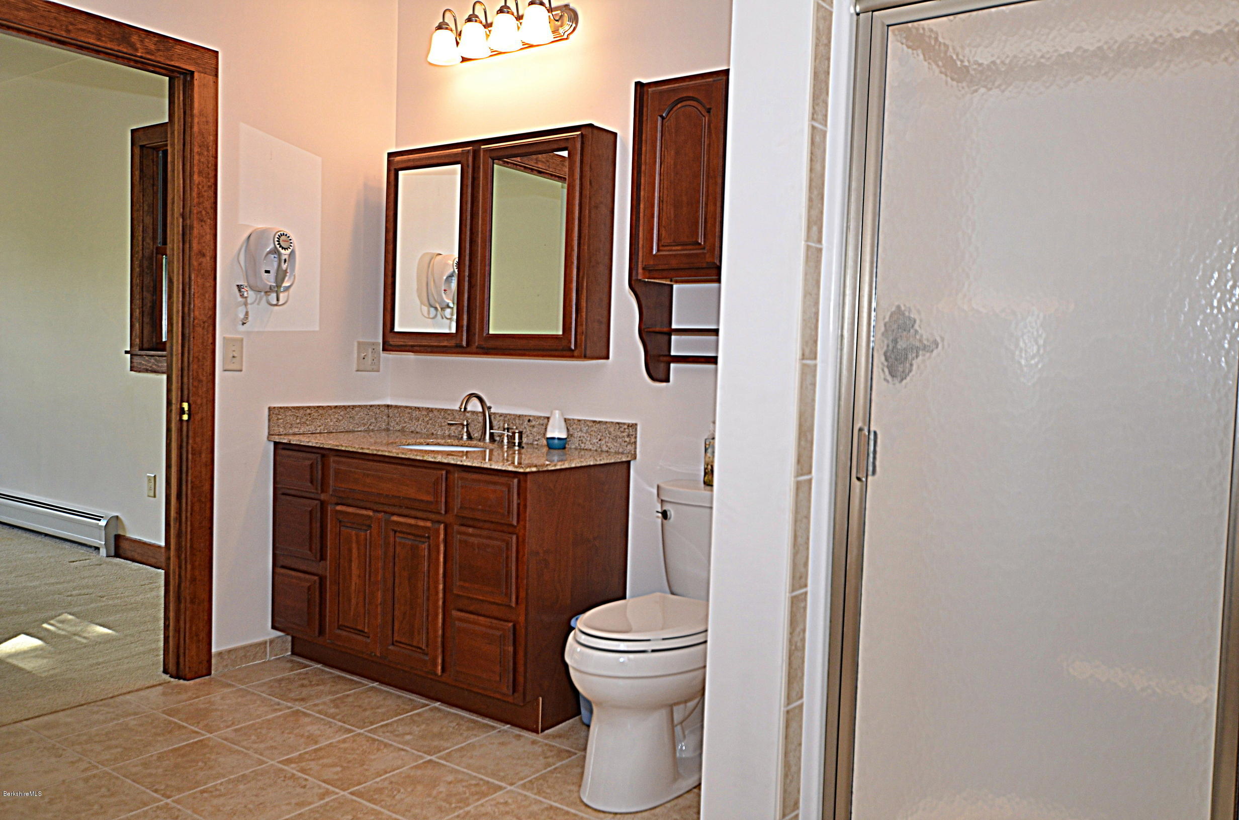 779 Stebbins Road Otis, MA 01253 - Photo 25 of 40 a bathroom with a toilet a sink and mirror