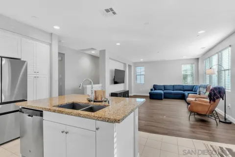 a living room with furniture a large window and a potted plant