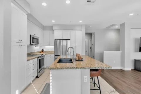 a kitchen with refrigerator and stove