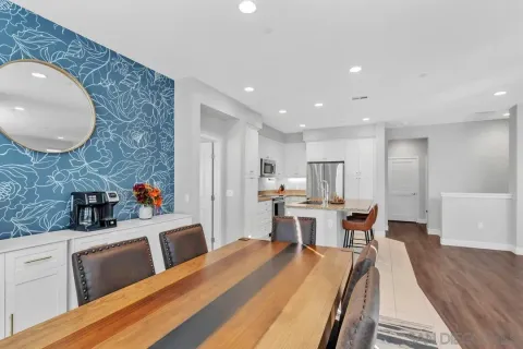 a large kitchen with a table and chairs