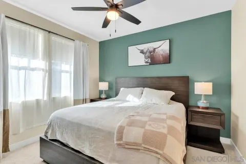 a bedroom with a bed and a painting on the wall