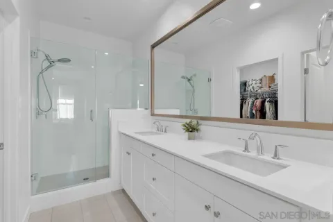 a bathroom with a granite countertop sink mirror and double