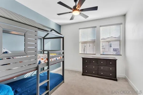 a spacious bedroom with a bed and a dresser