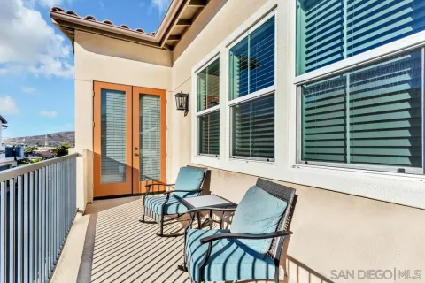 a view of a chairs and table in the balcony