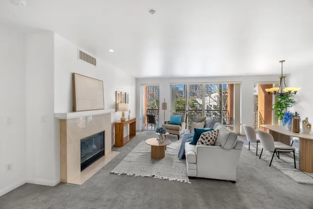 a living room with furniture a flat screen tv and a large window
