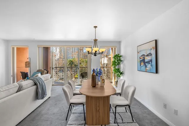 a kitchen with stainless steel appliances a sink a stove a refrigerator cabinets and a window