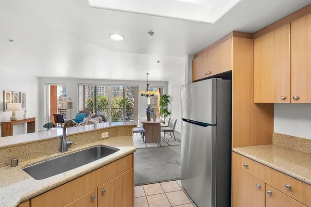 a kitchen with granite countertop white cabinets and stainless steel appliances