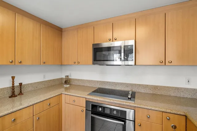 a view of a kitchen counter top a sink and living room