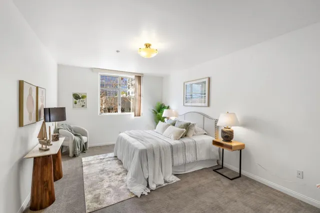 a bedroom with a bed and a potted plant