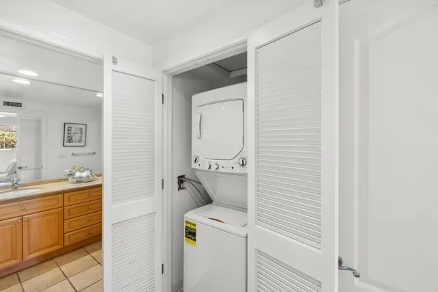 a bathroom with a granite countertop sink a large mirror and a bath tub