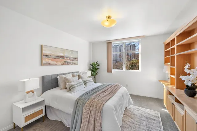 a bedroom with a bed and a potted plant