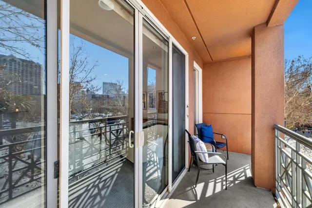 a room with furniture flat screen tv and floor to ceiling window