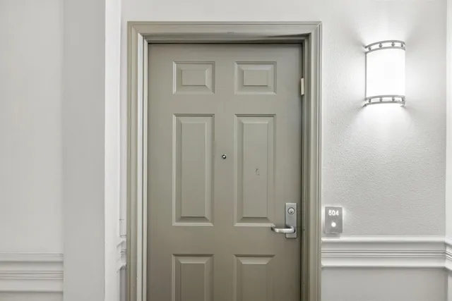 a living room with fireplace furniture and a large window