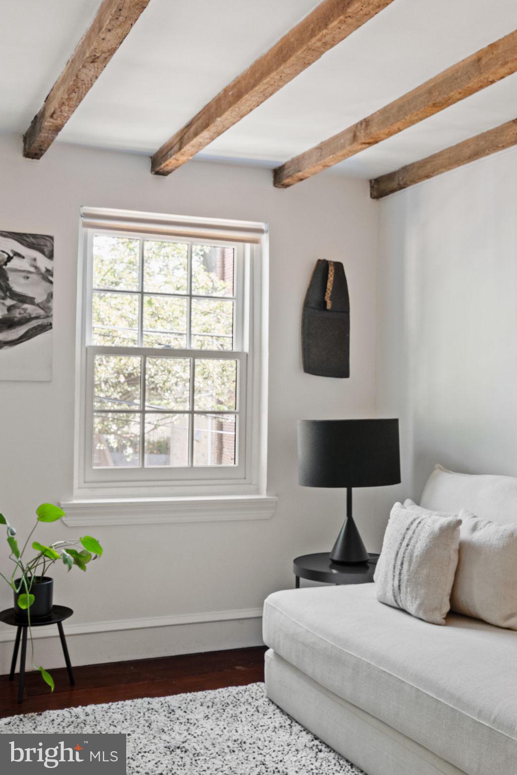 142 Carpenter Street Philadelphia, PA 19147 - Photo 25 of 49 a bedroom with a bed a dresser next to a window
