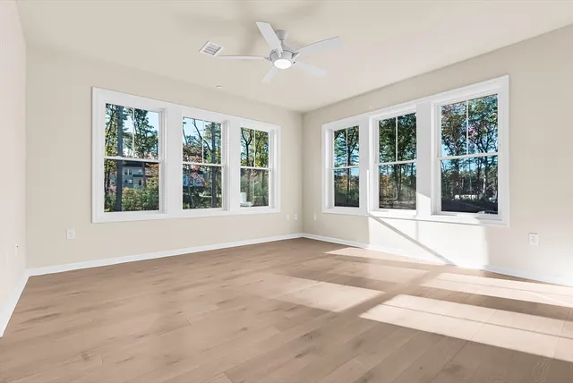 a view of an empty room with a window and balcony