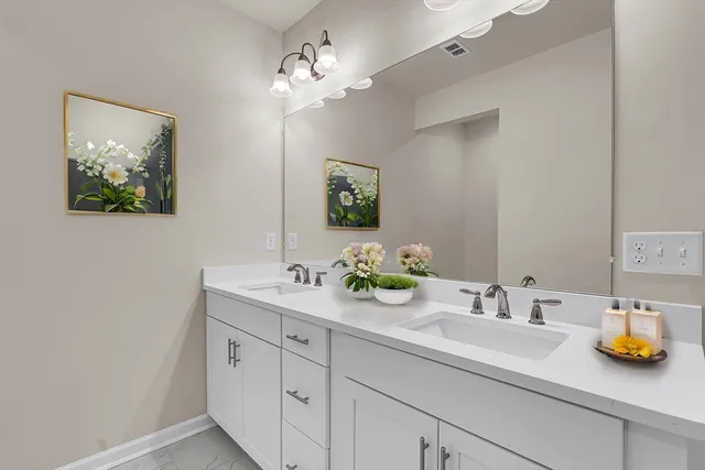 a bathroom with a sink double vanity and a mirror