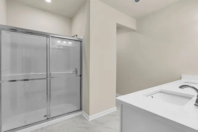 a bedroom with a large bed and a potted plant