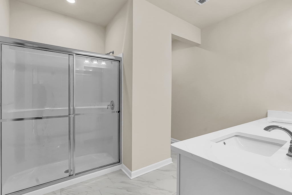 2 Winslow Lane, Unit 201 Grafton, MA 01536 - Photo 20 of 33 a bathroom with a shower sink and toilet