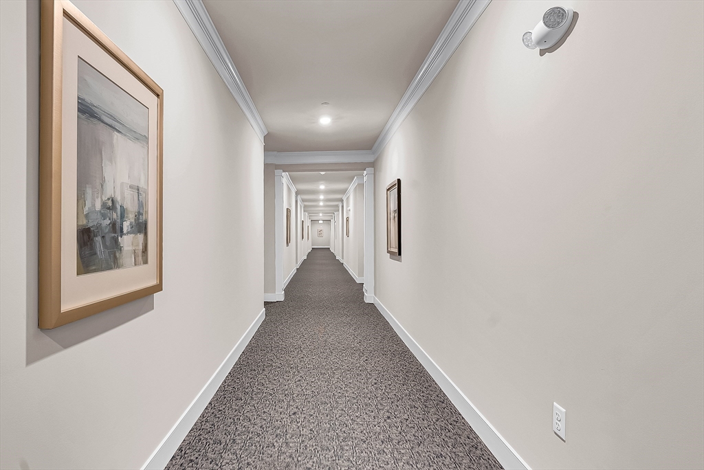 2 Winslow Lane, Unit 201 Grafton, MA 01536 - Photo 32 of 33 a view of a hallway with wooden floor and staircase