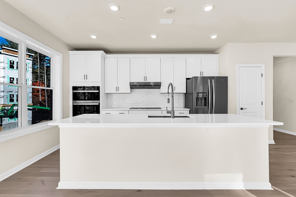 2 Winslow Lane, Unit 201 Grafton, MA 01536 - Photo 6 of 33 a large kitchen with stainless steel appliances a refrigerator and a stove top oven