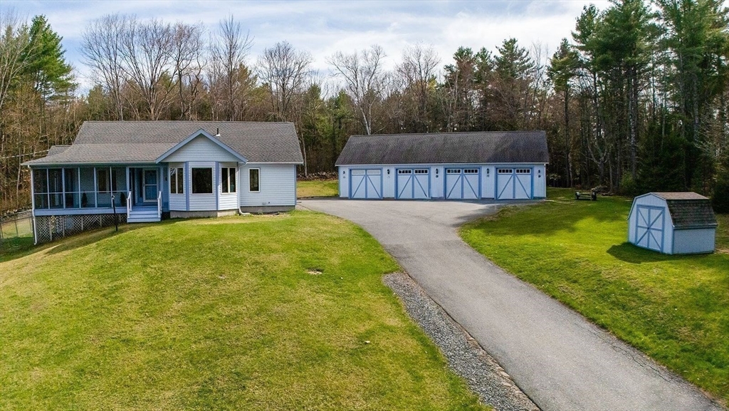a view of a house with a yard and fence