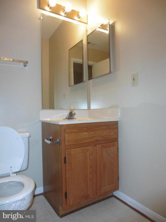 8817 Ritchboro Road District Heights, MD 20747 - Photo 16 of 19 a bathroom with a toilet sink and mirror