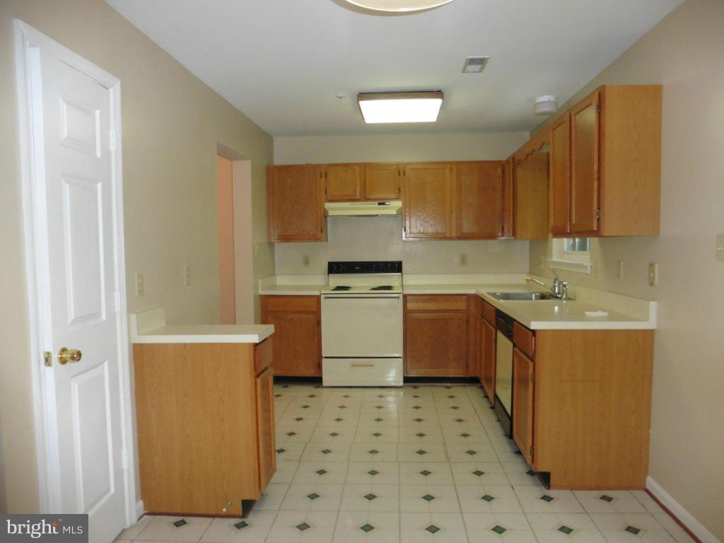 8817 Ritchboro Road District Heights, MD 20747 - Photo 7 of 19 a kitchen with a sink a stove top oven and cabinets
