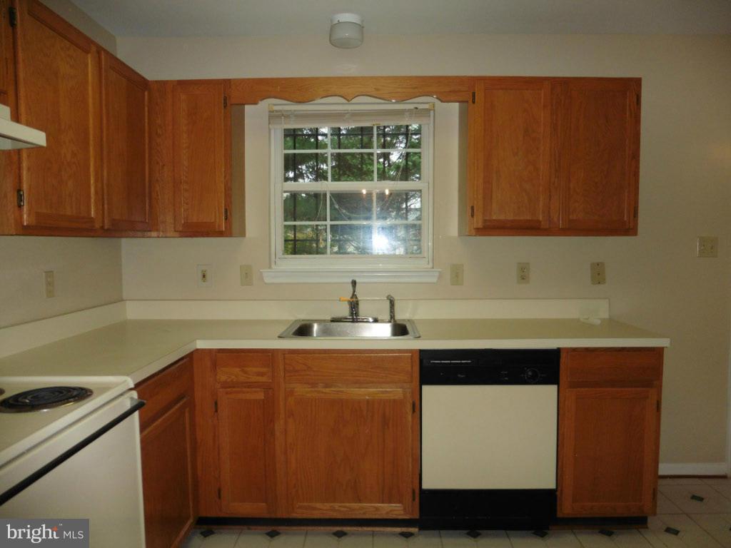 8817 Ritchboro Road District Heights, MD 20747 - Photo 9 of 19 a kitchen with a sink cabinets and window