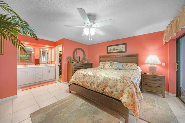 a bedroom with a large bed and a chandelier
