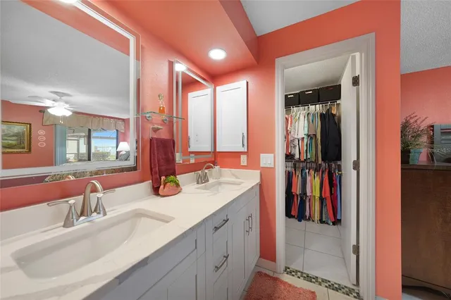 a bathroom with a double vanity sink and a mirror