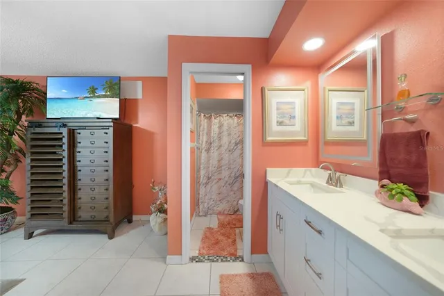a bathroom with a granite countertop sink a mirror and a shower
