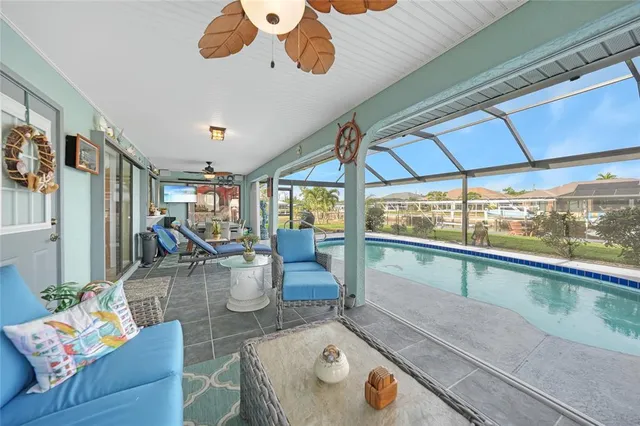a living room with furniture and a floor to ceiling window