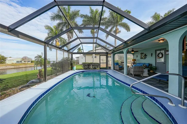 a view of swimming pool with a couches and wooden floor