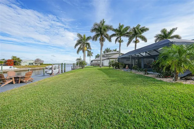 a view of a house with a yard and sitting area