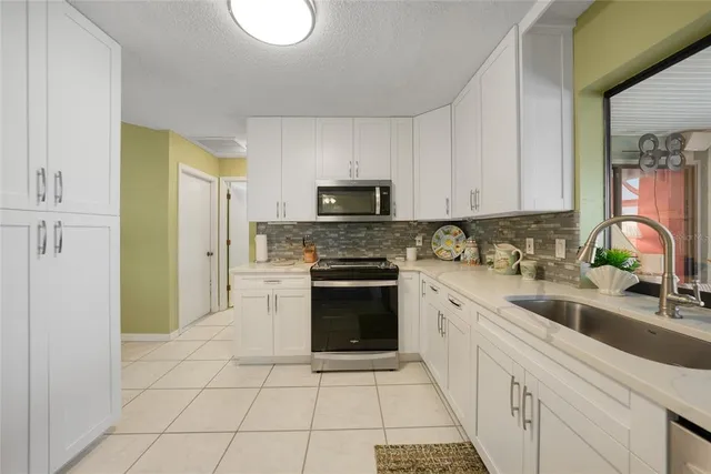 a kitchen with a sink cabinets and stainless steel appliances