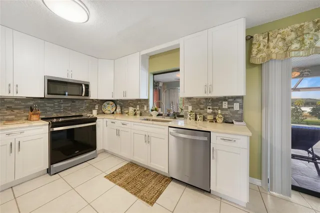 a kitchen with a stove top oven sink and cabinets