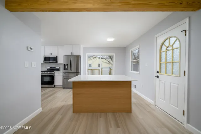 a view of kitchen with sink and wooden floor