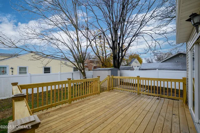 a view of a wooden deck with a yard