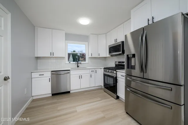a kitchen with a refrigerator stove and sink