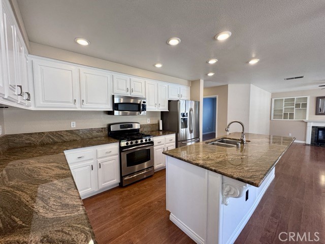 32948 Levi Court Temecula, CA 92592 - Photo 11 of 59 a kitchen with kitchen island granite countertop a stove sink and cabinets
