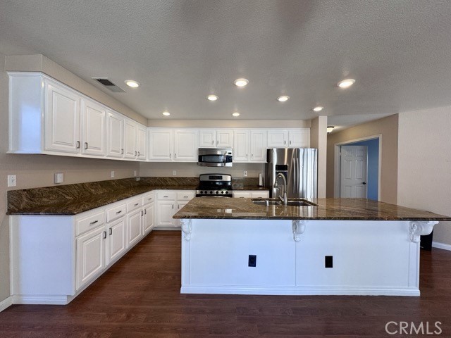 32948 Levi Court Temecula, CA 92592 - Photo 12 of 59 a large kitchen with stainless steel appliances granite countertop a stove a sink and a refrigerator