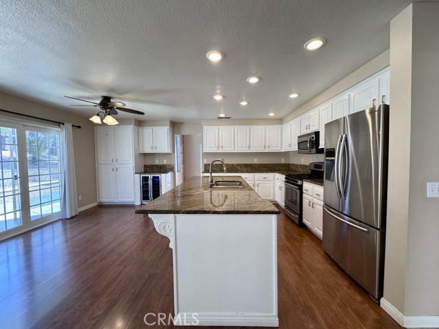 32948 Levi Court Temecula, CA 92592 - Photo 15 of 59 a kitchen with kitchen island a counter top space appliances and a refrigerator