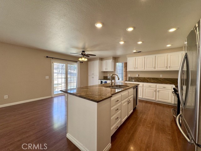 32948 Levi Court Temecula, CA 92592 - Photo 16 of 59 a large kitchen with stainless steel appliances granite countertop a lot of counter space and wooden floors